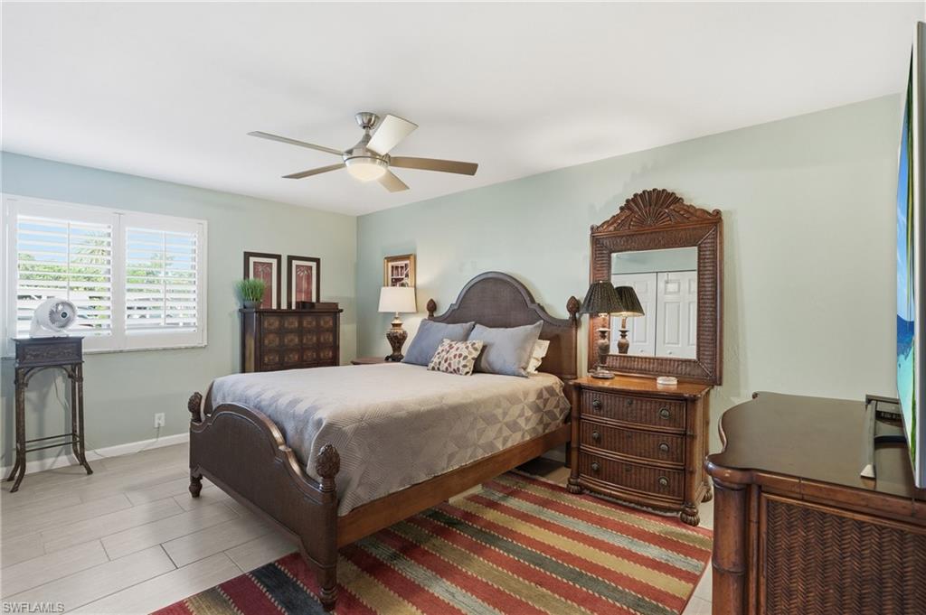 Bedroom featuring light wood-finish flooring and a ceiling fan with integrated lighting