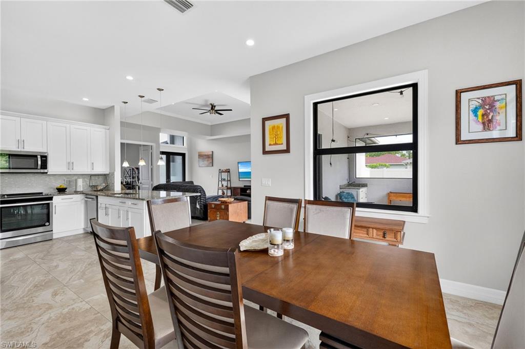 Open-concept living space with a dining area featuring a large window