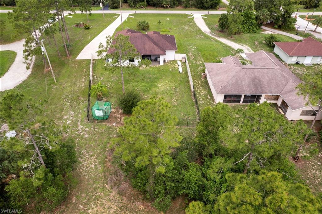 Expansive property with mature trees and a fenced boundary