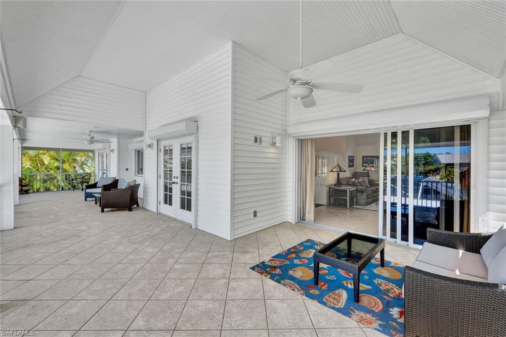 Spacious covered patio with light-toned tile flooring