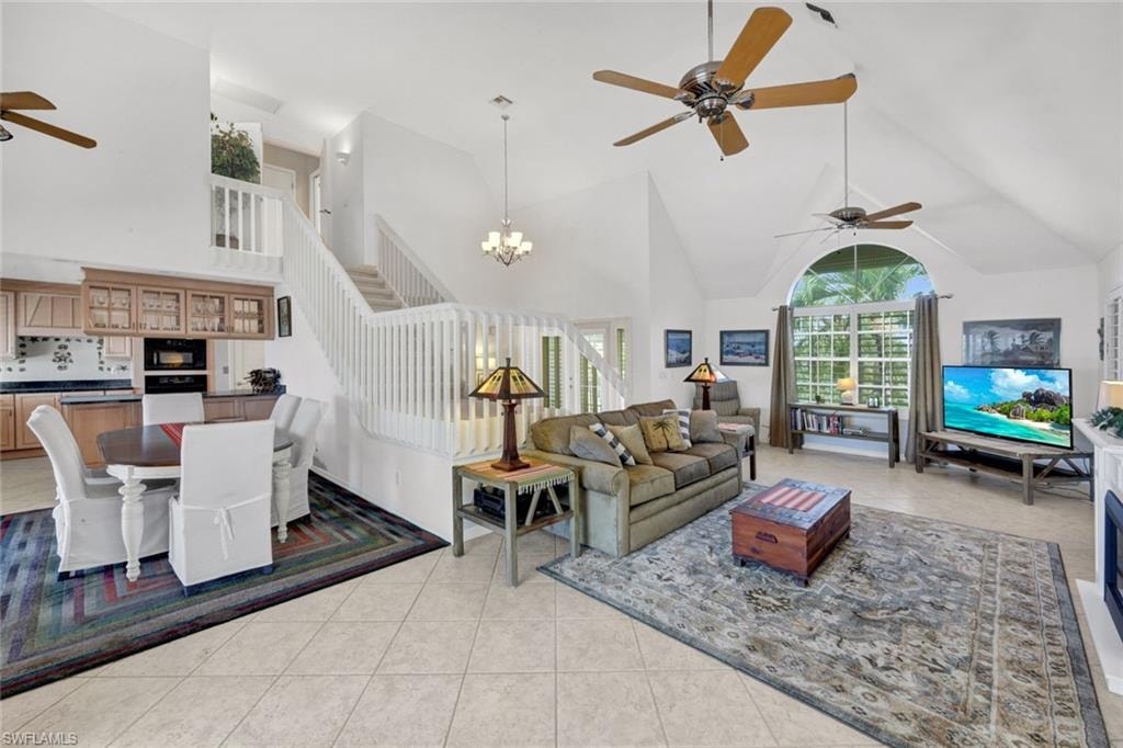 Open-concept living area with vaulted ceilings and a grand staircase