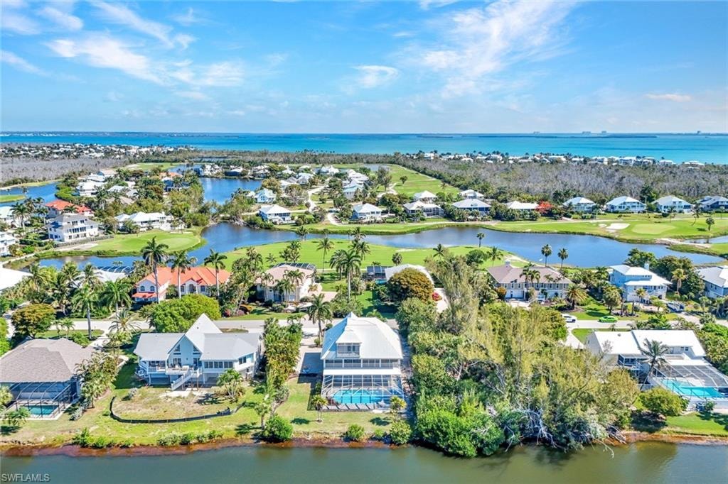 Coastal community featuring multiple properties, water frontage, and golf course access