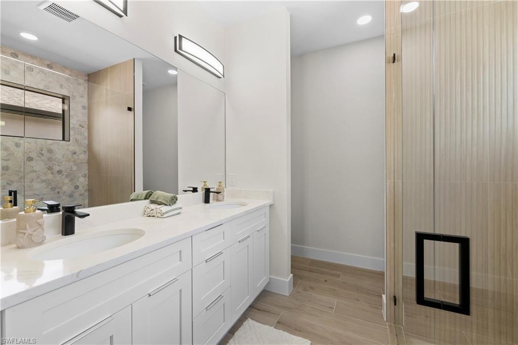 Dual vanity with white cabinetry and integrated sinks