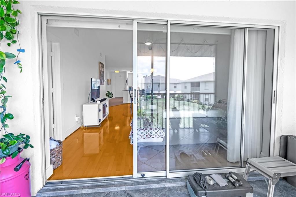Expansive sliding glass doors opening to an outdoor patio with textured tile flooring