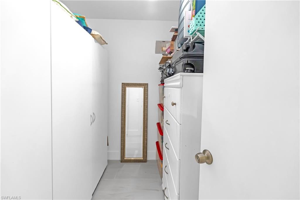 White built-in cabinetry with silver hardware provides ample storage