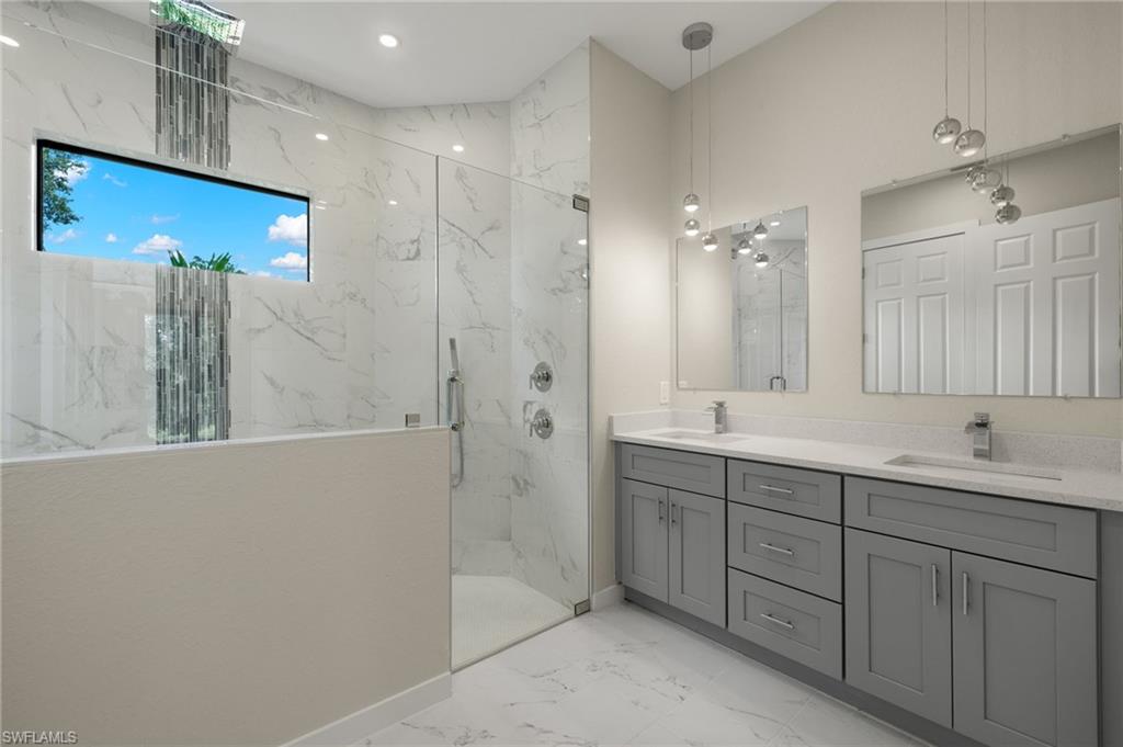 En-suite master bathroom with dual quartz vanities, premium lighting & custom XL shower