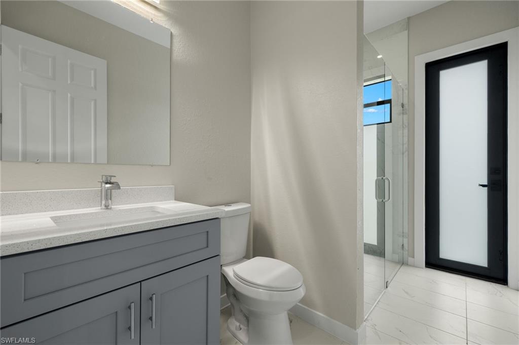 Guest bathroom with custom shower & separate access to backyard.