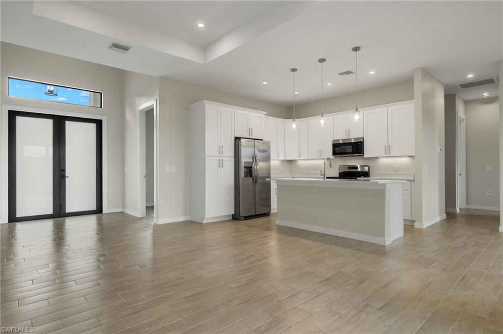 Flooring upgraded to premium, color-matched Luxury Vinyl Plank [LVP].