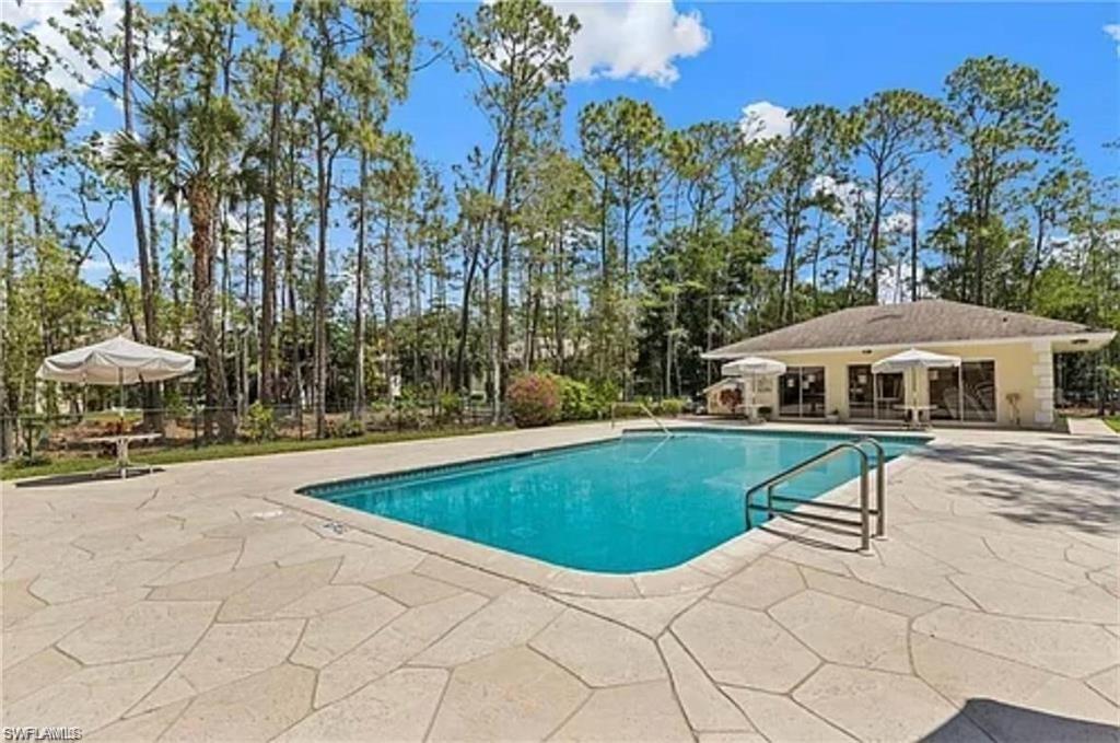 Rectangular swimming pool with integrated steps, surrounded by flagstone-style paving
