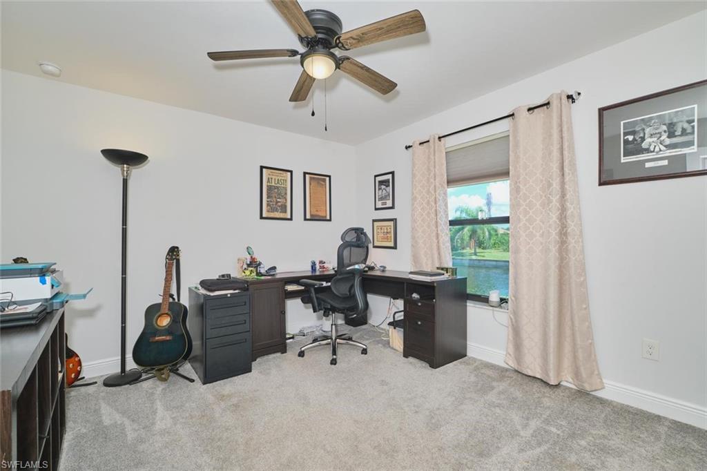 BEDROOM 2 featuring a ceiling fan with light, a window with blinds and curtains, and CANAL VIEW visible beyond the window