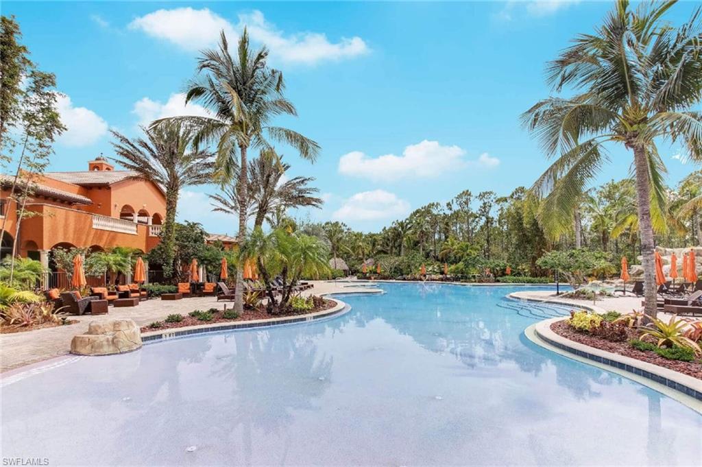 Expansive custom pool with a curved design and a surrounding paver patio