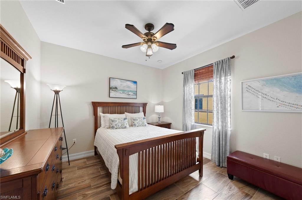 Secondary bedroom with neutral wall paint and wood-finish tile flooring define this space. NEW TILE FLOOR (2018)