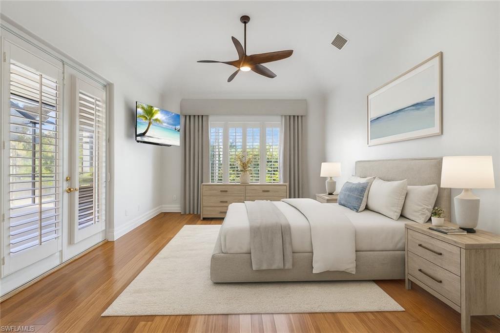 Your primary sanctuary is bathed in natural light and offers effortless access to the lanai—perfect for enjoying a quiet morning coffee in serene comfort. Designed for year-round enjoyment, this expansive under-truss living space provides seamless indoor-outdoor living regardless of the weather, creating an inviting and versatile retreat that embodies true Southwest Florida luxury. Virtually Staged Primary Bedroom