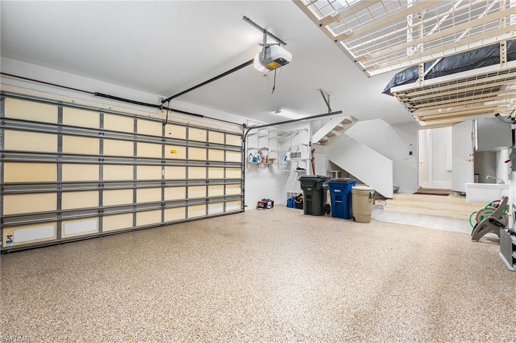 The garage is a true 2.5-car design, offering ample space to comfortably accommodate two vehicles along with a golf cart. Thoughtfully appointed with generous overhead storage and a beautifully finished epoxy floor, it blends practicality with a clean, polished aesthetic.