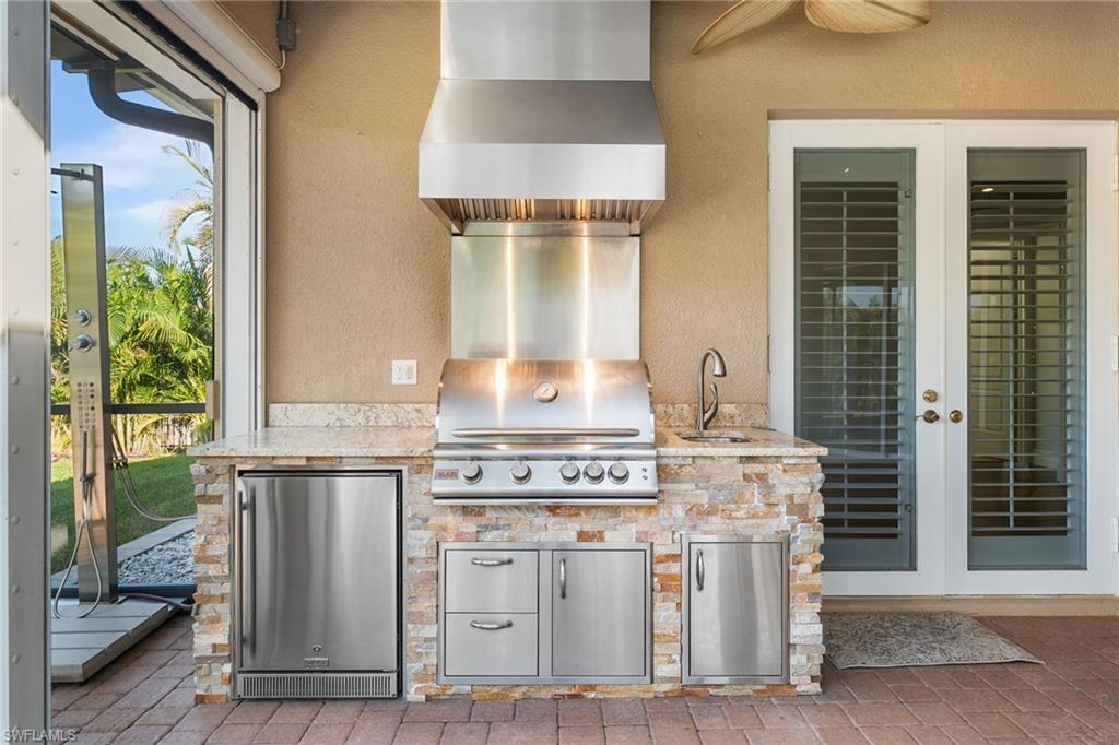 Custom designed pool with waterfall, pavered pool deck enhances the undertruss outdoor living area!