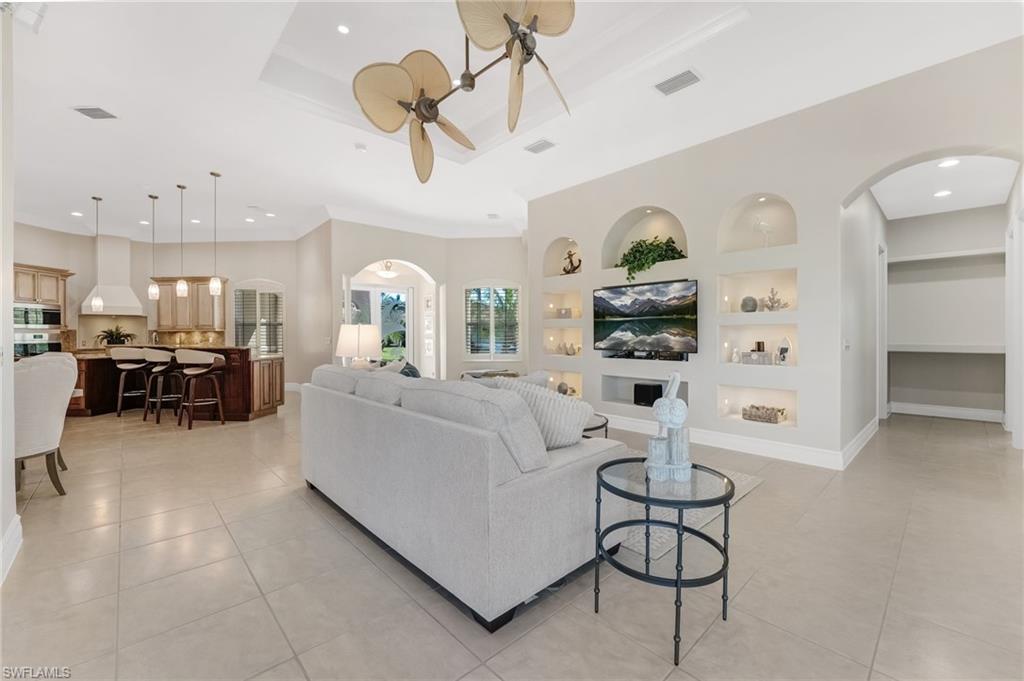 An open-concept design with custom built-ins creates a sophisticated yet inviting flow, perfectly suited for both grand-scale entertaining and intimate gatherings alike.