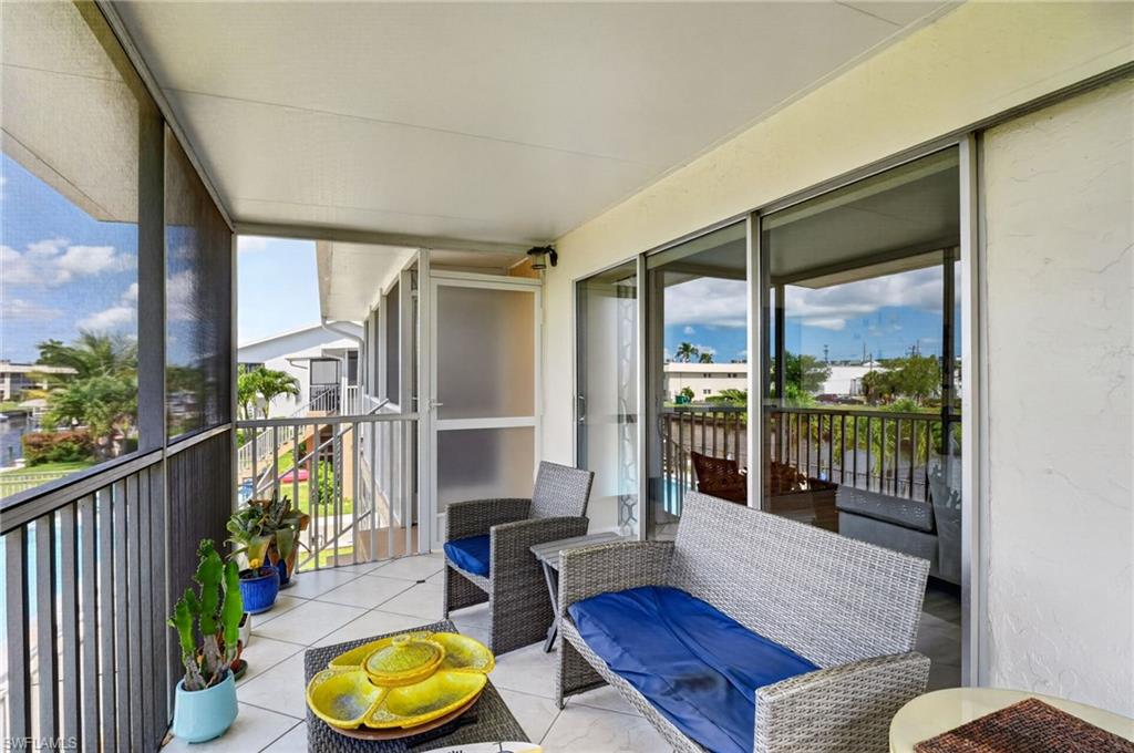 Screened balcony featuring white tile flooring and a white ceiling