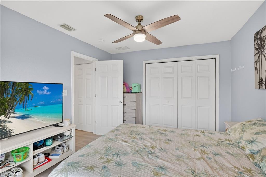 Bedroom featuring light blue walls and wood-finish flooring