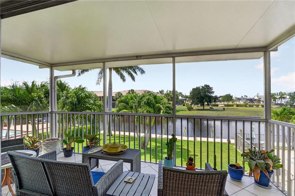 Screened lanai featuring a solid overhead roof, tiled flooring, and an aluminum railing