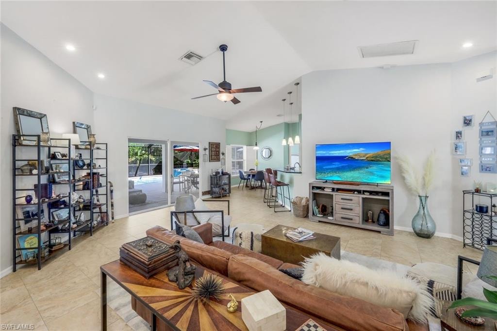 Living area with vaulted ceilings, recessed lighting, and tile flooring