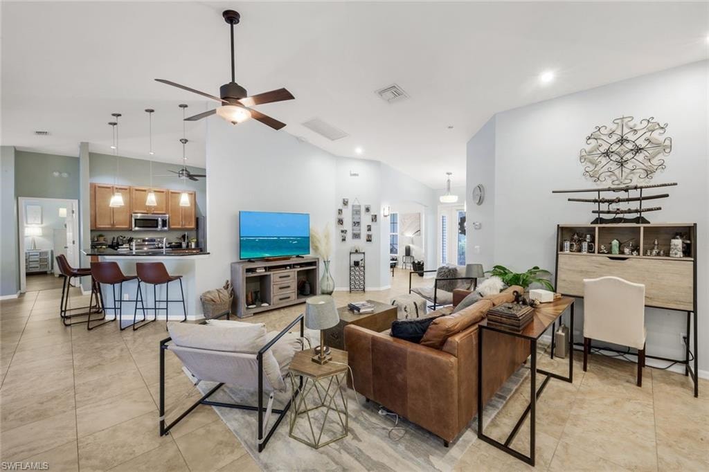Open concept interior featuring vaulted ceilings and tile flooring