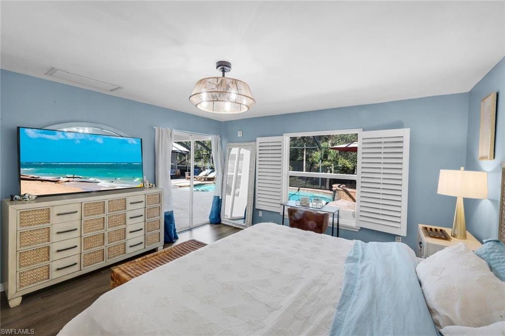 Wood-finish flooring throughout, featuring a glass sliding door providing direct access to the exterior and pool area