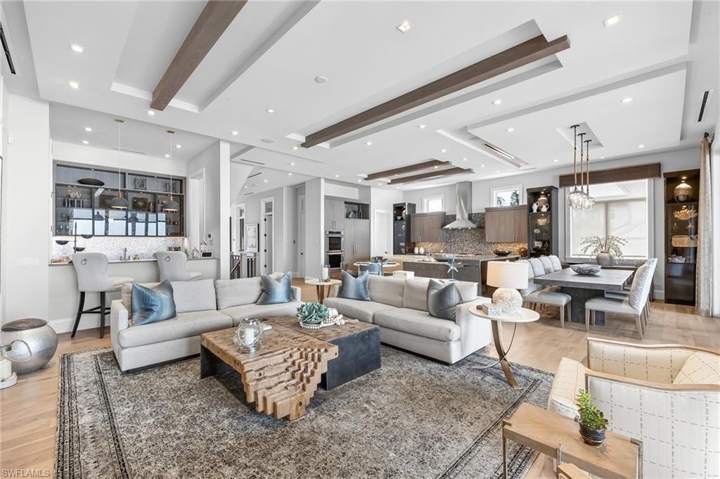 Open concept-view of living area, wet bar, kitchen & dining