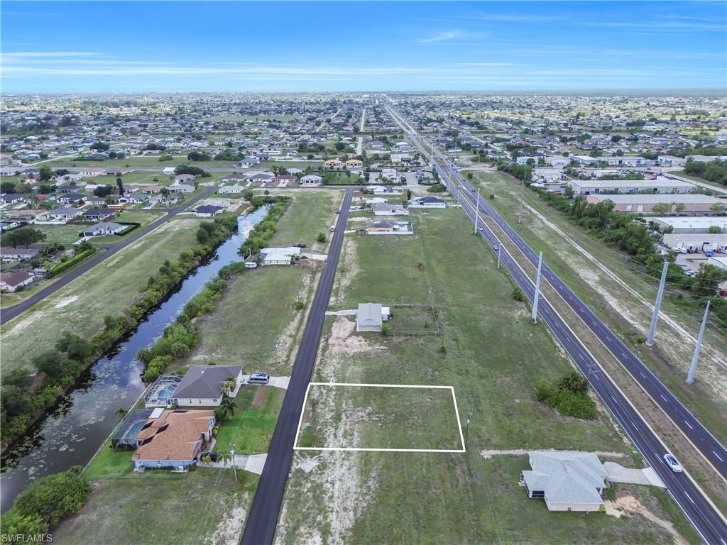 Vacant residential lot outlined in white, featuring clear ground for construction