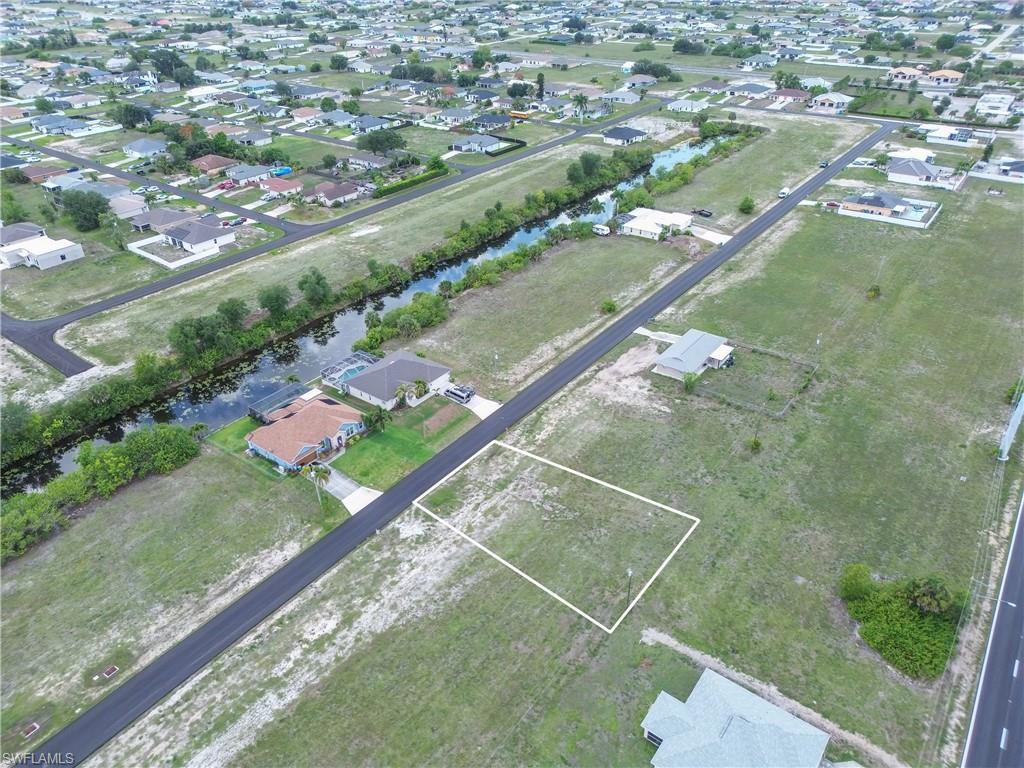 Cleared residential lot outlined in white, situated on a paved street