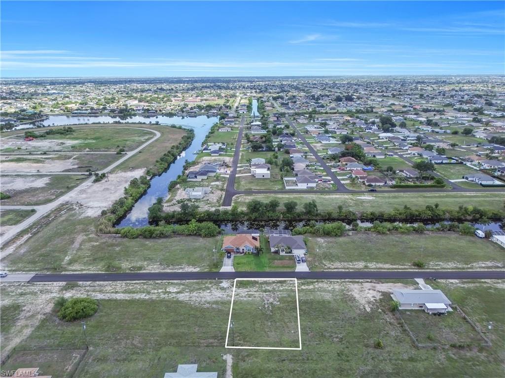 Vacant lot outlined in white, featuring a flat, grassy topography