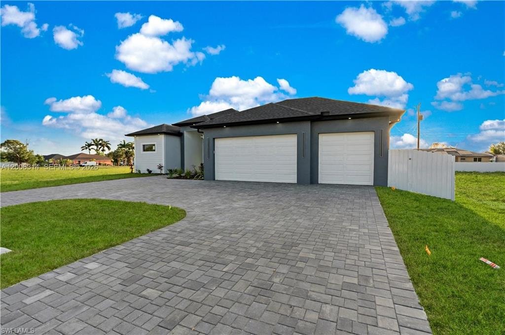 Contemporary exterior featuring a paver driveway, two-car garage, and a single-car garage