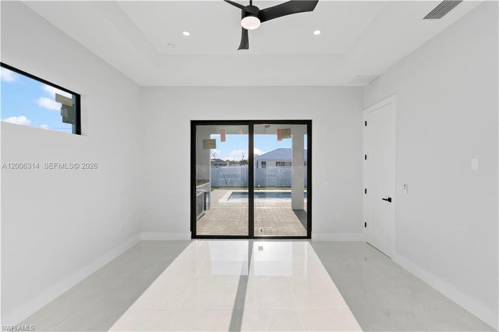 Spacious interior featuring a coffered ceiling, recessed lighting, and polished tile flooring