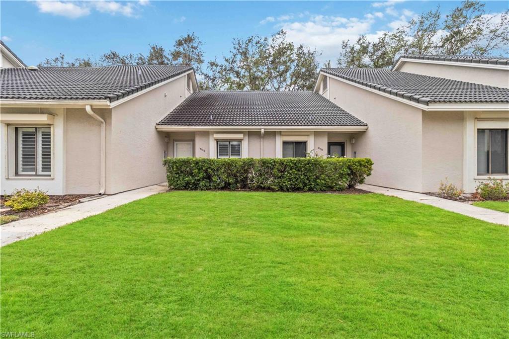 Back of property featuring a yard