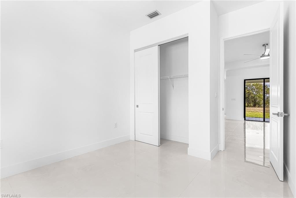 Bright interior space featuring light-toned flooring, white walls, and a sliding closet door