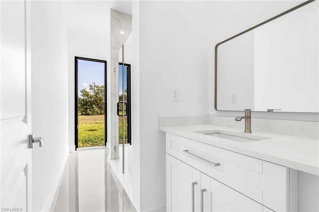Modern bathroom vanity with a white countertop and undermount sink