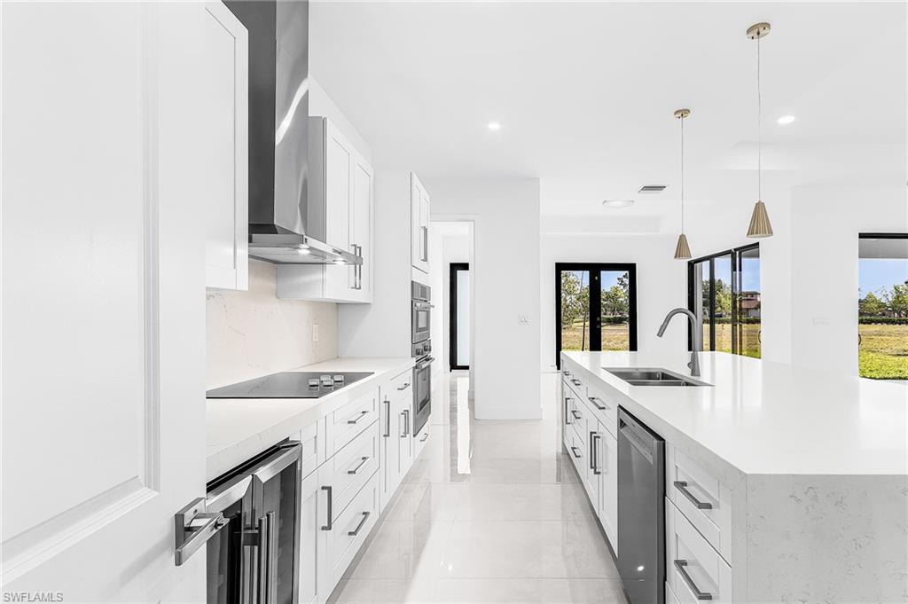 Contemporary kitchen featuring an expansive island with an undermount sink and gooseneck faucet