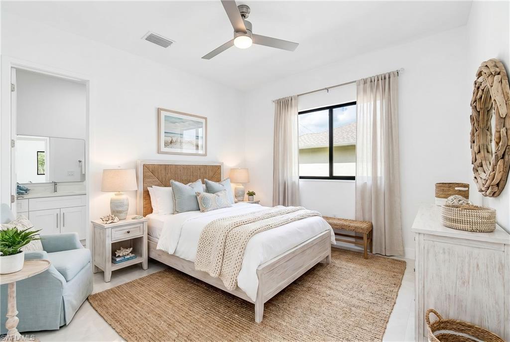 Bright bedroom featuring a ceiling fan, white walls, and a window with light-filtering drapes