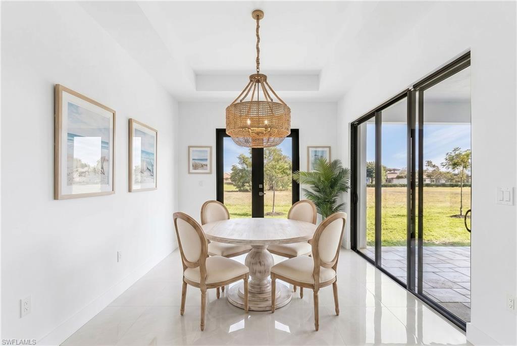 Dining space featuring a coffered ceiling and a natural fiber chandelier