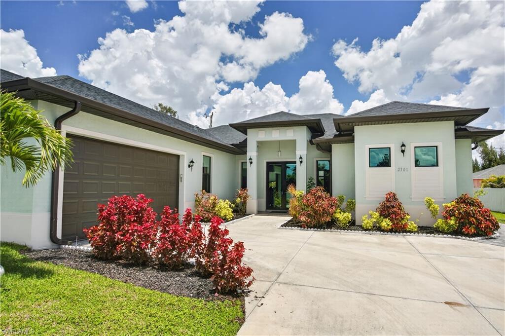From the moment you arrive, the TROPICAL LANDSCAPING, OVERSIZED DRIVEWAY (side garage with plenty of driveway space!) and elegant modern elevation create impressive CURB APPEAL in true FLORIDA style!
