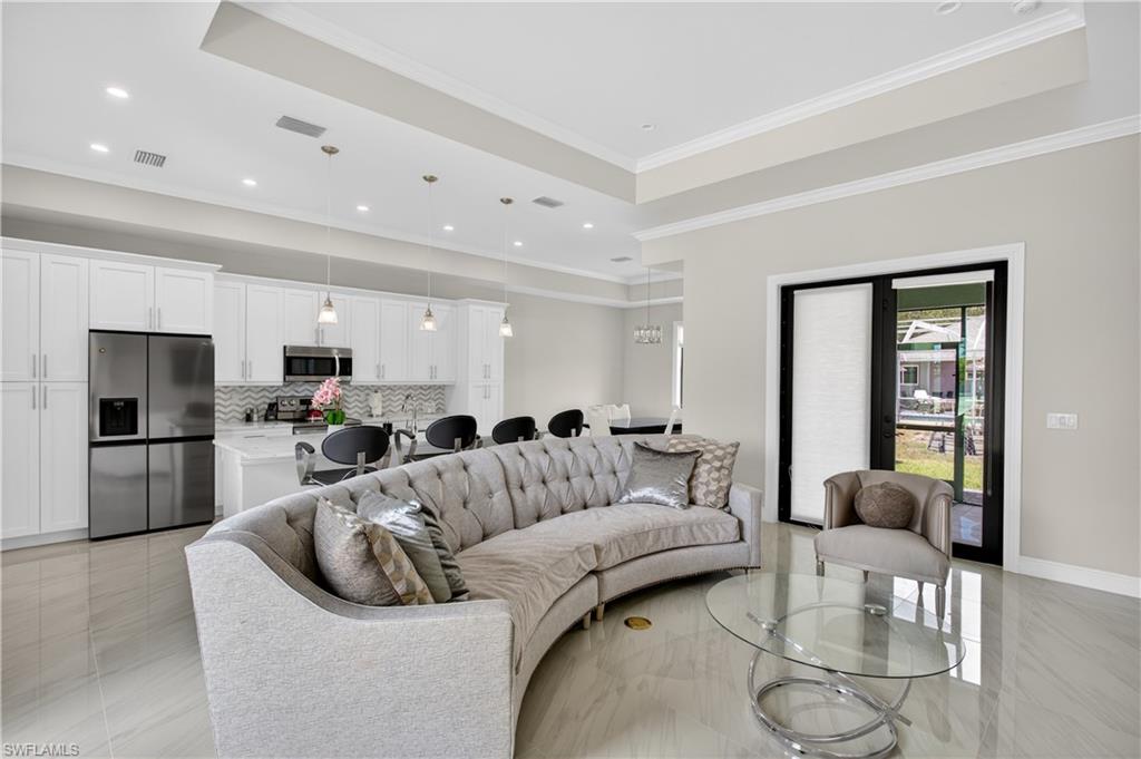 The SPACIOUS LIVING ROOM seamlessly connects to the CHEF-INSPIRED KITCHEN