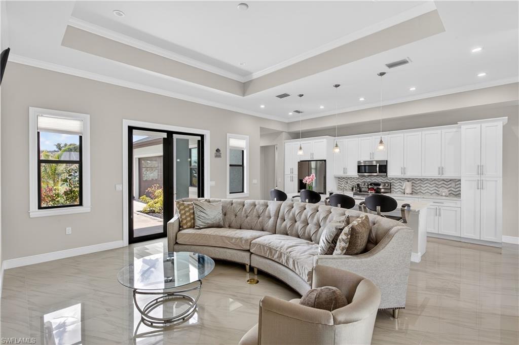 Step inside to soaring TRAY CEILINGS, abundant NATURAL LIGHT and beautiful LARGE-FORMAT TILE FLOORING throughout the entire home, creating a clean, elegant and LOW-MAINTENANCE atmosphere.
