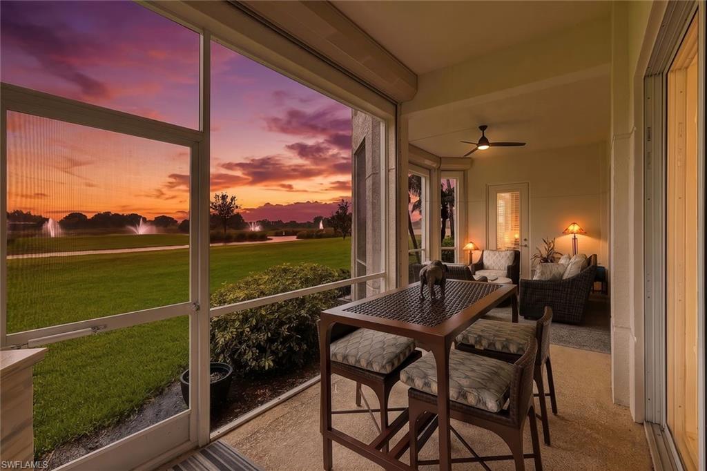 Screened patio with concrete flooring and a ceiling fan, offering expansive views of  the water features
