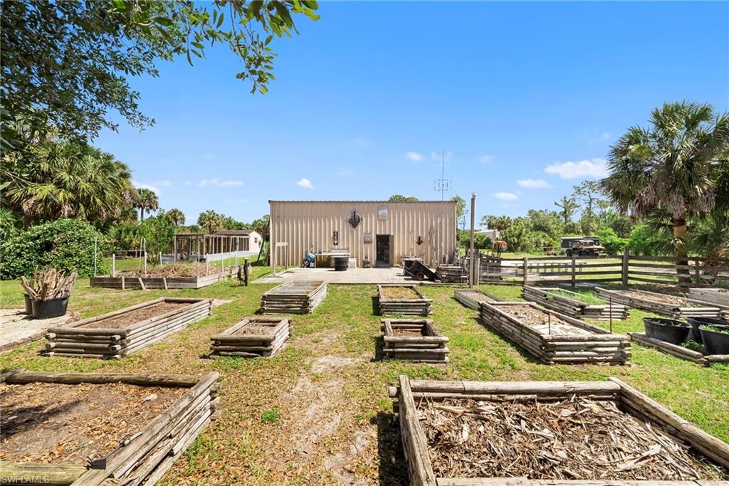 Expansive outdoor space featuring multiple raised garden beds