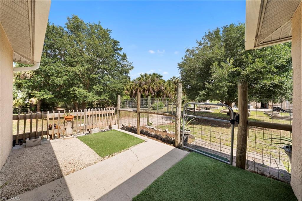 Paved patio with sections of artificial turf and gravel