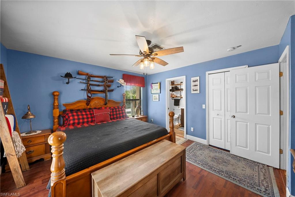 Room featuring wood-finish flooring and a ceiling fan with light fixture