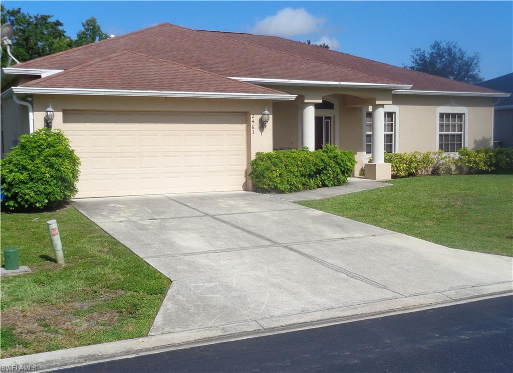 Front Left-side view of single-story home with a 2-car garage, driveway, shingle roof, and stucco siding