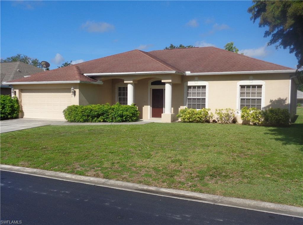 Front Right-side view of single-story home with a 2-car garage, driveway, shingle roof, and stucco siding