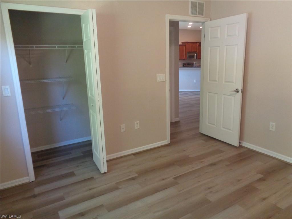 Guest Bedroom 1 with closet and wood-like flooring