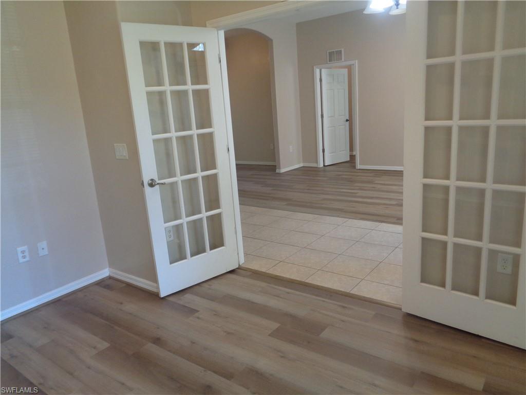 View of the Den, featuring wood-style flooring and double French doors