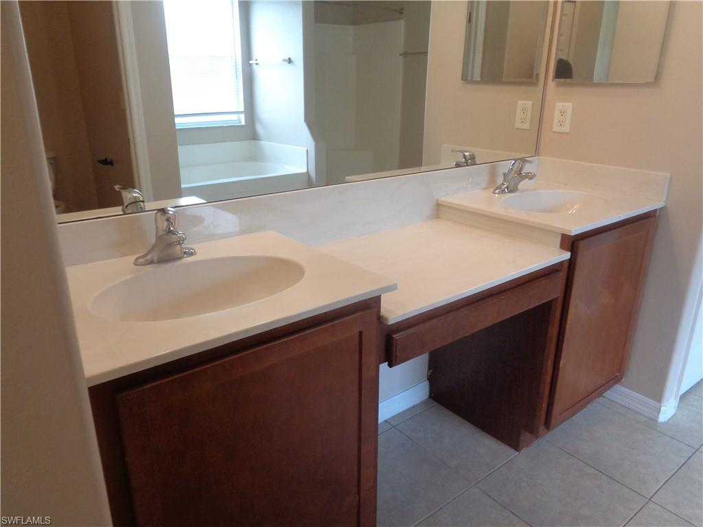 View of the Master Bedroom's bathroom with double sink vanity and tile flooring